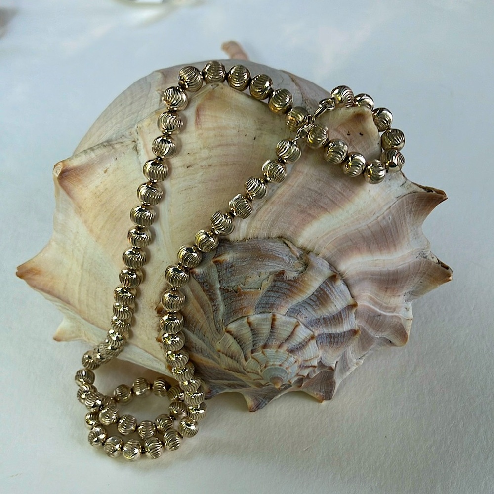 Small Silver (.90) etched bead necklace about 16 inches long.